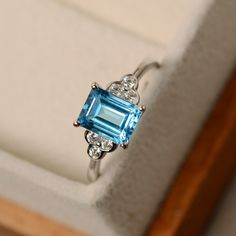 This ring features a 6*8mm emerald cut Swiss blue topaz and sterling silver finished with rhodium. Customization is available. It is made by hand, and it will take about 7 days to finish the ring after your payment is completed. Main stone: Swiss blue topaz Main stone weight: Approx 1.90 ct Metal type: sterling silver finished with rhodium Accent stone: cz Customization is available, I also can make it with 14k solid gold (white or yellow or rose) and diamond accent stone, just feel free to cont Blue Topaz Ring Silver, Jewerly Ring, Antique Rings Vintage, Swiss Blue Topaz Ring, Blue Topaz Jewelry, Sparkly Ring, Blue Diamond Ring, Topaz Jewelry, Gold Rings Fashion