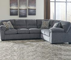 a living room with a sectional couch and rug