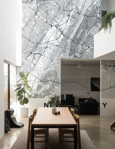 a dining room table and chairs in front of a wall with a map on it