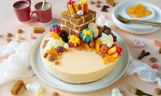 there is a cake on the table with many candies and other treats around it