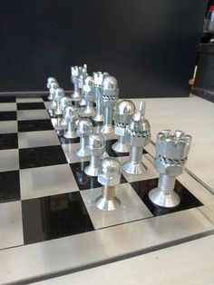 a chess board with metal pieces on it