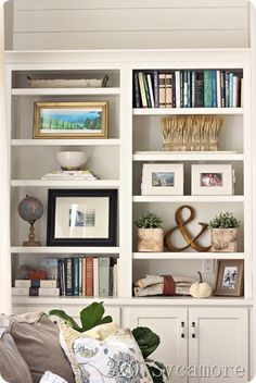 a white bookcase filled with lots of books