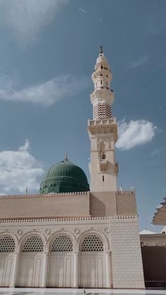 a large white building with a green dome