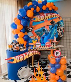 an assortment of balloons and decorations for a hot wheels birthday party