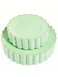 three green plates stacked on top of each other with gold trimmings and scalloped edges