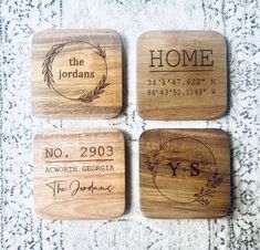 four wooden coasters with names and date engraved on the front, one for home