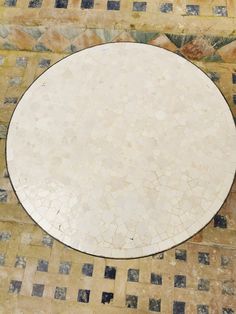 a white table sitting on top of a tiled floor