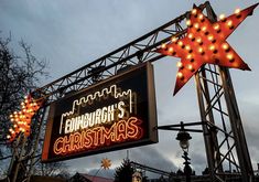 a sign that is lit up with christmas lights