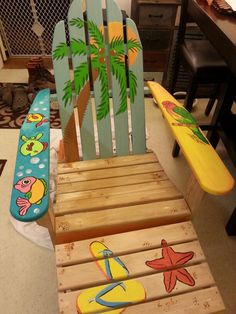 a child's wooden chair with surfboards painted on it