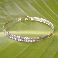 "A terrific little bracelet of six strands of wire--two plain 14kt gold filled wires on the inside, flanked by four sterling silver twist wires on the outside. Charming, comfortable, and feminine, and two-tone is really \"in\" right now! The sturdy built-in hook and eye clasp is easy to get on and off by yourself. This bracelet can also be made in all 14kt gold filled or all sterling silver. They would look AMAZING all three stacked together! Choose your size from the variations listed for a cus Gold Multi-strand Stackable Bracelets, Adjustable Double Band Gold Bracelet, Adjustable Double Band Gold Bracelets, Gold Adjustable Double Band Bracelet, Gold Double Band Adjustable Bracelets, Gold Multi-strand Stackable Jewelry, Gold Adjustable Double Strand Bracelet, Gold Braided Friendship Bangle Bracelet, Handmade Multi-strand Gold Bracelets