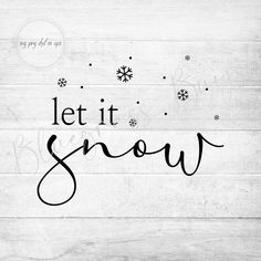 the words let it snow written in black ink on a white wooden background with snowflakes