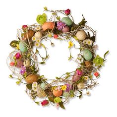 an easter wreath with flowers and eggs on the front is displayed against a white background