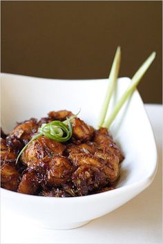 a white bowl filled with food on top of a table