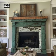 a living room with a fire place and bookshelves on the wall above it