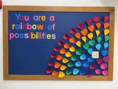 a bulletin board with colorful paper hearts attached to it and the words you are a rainbow of possibilities