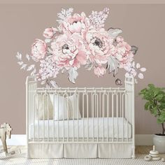 a white crib with pink flowers on it