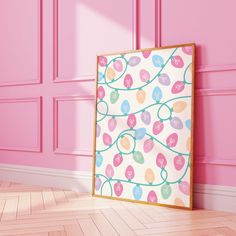 a pink room with a painting on the wall and wooden floor in front of it