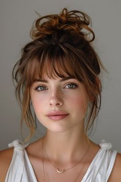 Add a sophisticated edge to your style with these 10 updos with bangs, blending elegance with contemporary chic. Bangs With Part In The Middle, Messy Fringe Bangs, Brunette Bangs Straight Hair, Short Ponytail Hairstyles With Bangs, Women's Haircuts With Bangs, Blonde Bangs Ponytail, Fun Edgy Haircut, Low Bun Wedding Hair Bangs, Low Maintenance Bangs Short Hair