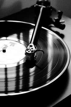 an old record player with its turntable spinning on it's side in black and white