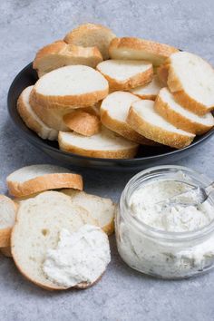 sliced bread and spread in a bowl next to a jar of mayonnaise on a table