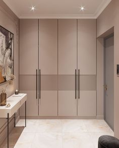 a large walk in closet with beige walls and flooring next to a white counter top