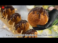 chocolate covered croissants on sticks with flowers in the background and text that reads pain au chocolat supreme new york rolls