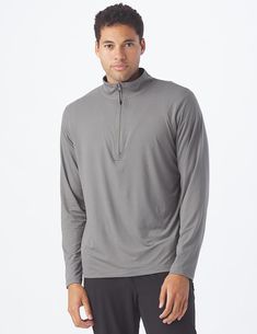 Can a top be cozy and sleek? Meet the Tahoe Quarter Zip. With this top, you’ll never have to sacrifice warmth for style. Superior stretch and quick drying technology make it an obvious choice as your #1 warm but not too warm layer. Athleisure Half-zip Top With Thumbholes, Long Sleeve Moisture-wicking Activewear, Long Sleeve Moisture-wicking Activewear For Layering, Functional Long Sleeve Tops For Loungewear, Gray Go-dry Sportswear Top, Winter Half-zip Loungewear Tops, Winter Loungewear Half-zip Tops, Winter Loungewear Tops With Half-zip, Half-zip Sport Tops For Fall