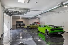 two green sports cars parked in a garage