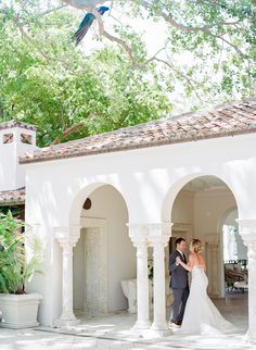 a bride and groom standing in an archway