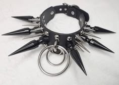 "Leather \"Hysteria\" black metal choker made of genuine leather, approx. 40 mm in the widest part and 25 mm in the narrowest part. Rings of 50 mm, 30 mm and 15 mm in diameter are connected with bridge buckle. The large black spikes are handmade and are 70 mm high. Metal spikes of 40 mm height and spikes of 25 mm height. The choker is specific because of the rivets in the shape of a mushroom/dome, which give it an interesting and sophisticated look. It is massive but not too heavy for the neck. Grunge Party, Biker Chain, Silly Clothes, Metal Choker, Goth Accessories, Metal Spikes, Gothic Chokers, Concept Clothing, Choker Collar