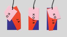 three pieces of paper with the word kola on them hanging from black string attached to each other