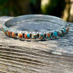 Spiny Oyster never goes out of style because it's just so darn pretty.  It looks like a sunset with it's turquoise blue skies and yellows and oranges like the sun.  A bangle adds that perfect touch to your turquoise layering stack.  This bangle is a hard find because the stones go all around the bangle. * Genuine turquoise and spiny oyster  * Sterling Silver (Stamped 925) * Spiny goes all around bangle * With thumb tucked in measure around the widest part of your hand and around...nothing over 8 Spiny Oyster, Southwestern Style, Silver Bangle, Genuine Turquoise, Blue Skies, Silver Bangles, Bracelet Sizes, Out Of Style, Turquoise Blue