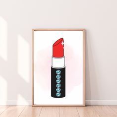 a red lipstick bottle with blue crystals on the bottom is displayed in front of a white wall