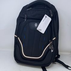 a black backpack sitting on top of a white table