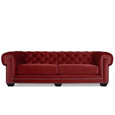 a red couch with white piping on the arms and back, in front of a white background