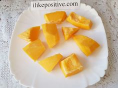 slices of mango on a white plate with lace doily