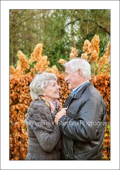 an older man and woman standing next to each other