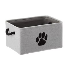 a grey storage box with a paw print on the front and bottom, it has black handles