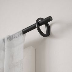 the curtain is hanging on the wall with an umbrella hook attached to it's side