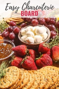 a platter filled with crackers, cheese and strawberries