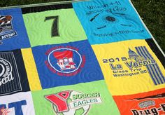 a quilted blanket with many different logos on it, including one for the team