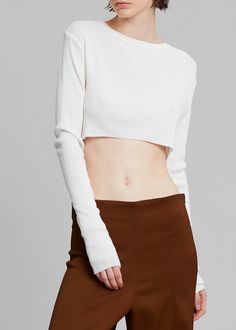 Color: WhiteLightweight ribbed knit with stretch Cropped profileSlim fitCrew necklineLong sleevesInvisible stitched hemUnlined85% Rayon 15% PolyesterDry CleanImported Cropped Knit Top, Invisible Stitch, Knit Crop Top, Knit Top, Ribbed Knit, Crop Tops, Knitting, Women's Top, White