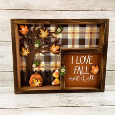 a wooden frame with pumpkins and fall decorations in it that says i love fall