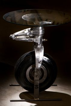 a glass table with metal wheels on it