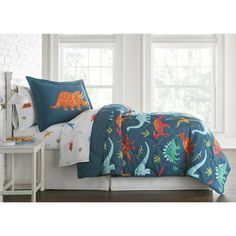 a bed with dinosaurs on it and blue sheets