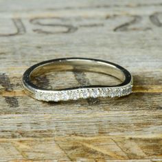 a close up of a wedding ring on a wooden surface