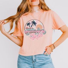 Looking for a cute versatile top to wear? Make sure to grab one of our Graphic tees! This soft and comfortable graphic tee is the perfect top for any outfit. It can be paired with biker shorts, jeans, or even a simple skirt/dress! This tee is true-to-size, so be sure to order your regular t-shirt size! If you are looking for a more oversized look, make sure to size up! Boxy Crop Top, Cropped Graphic Tees, High Neck Tank Top, Lace Splicing, Floral Jumpsuit, Cable Knit Cardigan, Cropped Tee, Vintage Shorts, Soft Ring