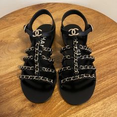 Chanel Sold Out Current Season Black Sandals With Silver Chain. Size 37.5 Brand New Never Worn With Original Box And Dusters. Bought In Chanel Boutique In San Francisco. Channel Strap Sandals, Luxury Black Sandals With Chain Strap, Chanel Puffy Sandals, Chanel Sandals 2022, Chanel Thong Sandals, Chanel Black Sandals, Ribbon Sandals, Chanel Slingback, Chanel Sandals