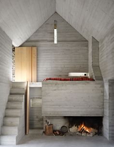 an instagramted photo of a room with stairs and a fire place in it