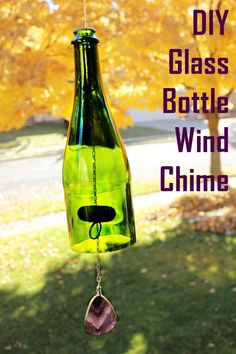 a glass bottle wind chime hanging from a tree